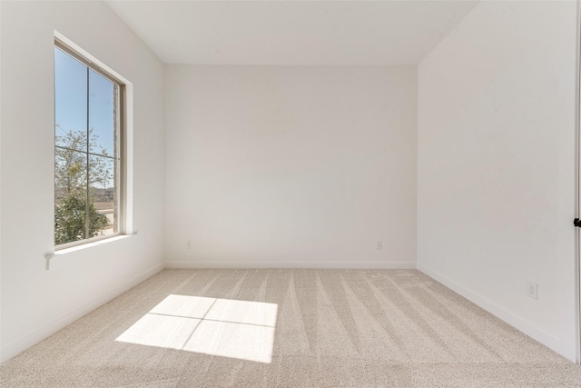 unfurnished room with carpet floors and baseboards