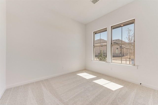 spare room with carpet floors and baseboards