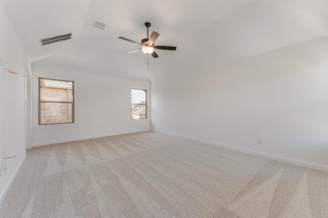 spare room with baseboards, visible vents, and light colored carpet