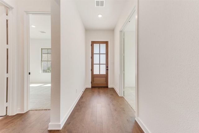 entryway with a healthy amount of sunlight, visible vents, and wood finished floors