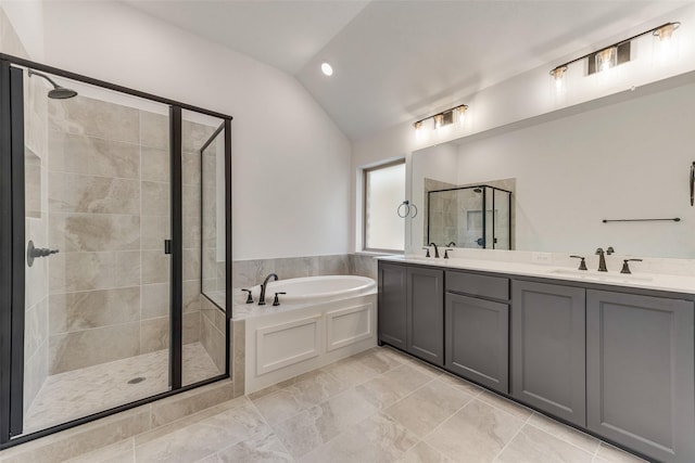 full bath featuring a bath, a stall shower, a sink, and lofted ceiling