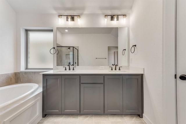 full bath featuring a garden tub, double vanity, a stall shower, and a sink