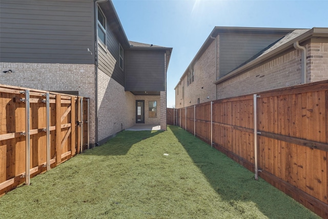 view of yard with a fenced backyard