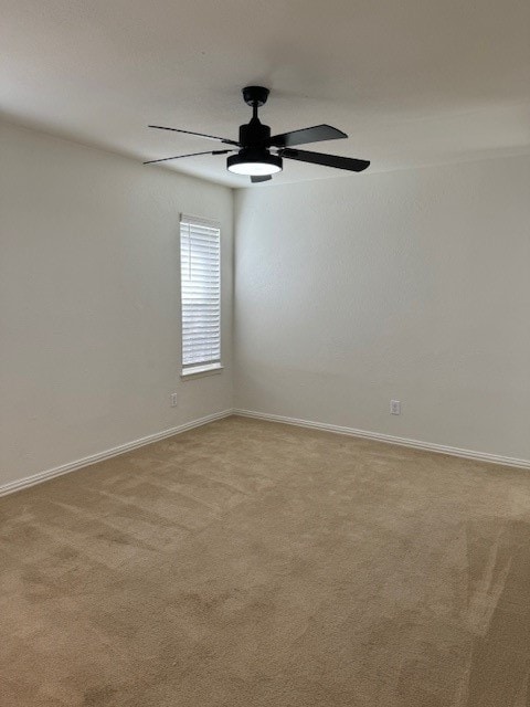 carpeted empty room with ceiling fan