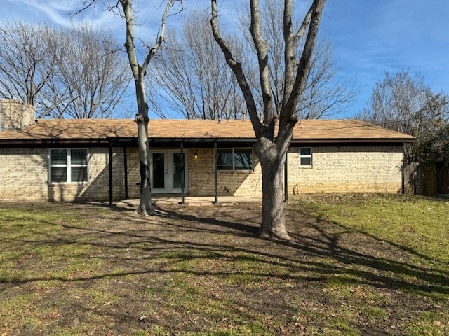 rear view of property with a yard and a patio area