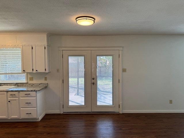 doorway to outside featuring french doors, a healthy amount of sunlight, and dark hardwood / wood-style flooring