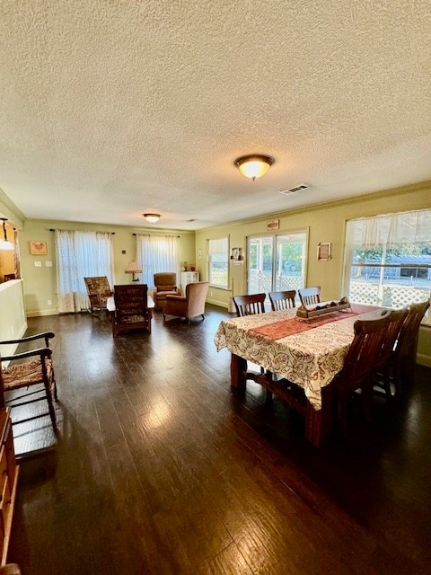 dining space featuring a textured ceiling and dark hardwood / wood-style floors