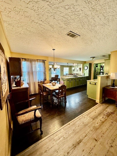 dining area featuring ornamental molding, a textured ceiling, and dark hardwood / wood-style flooring