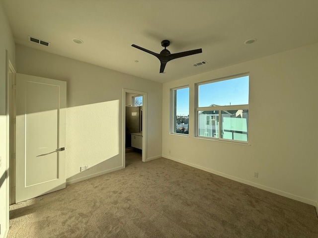 unfurnished bedroom featuring ceiling fan and carpet