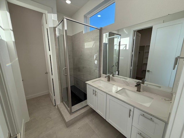 bathroom featuring walk in shower, vanity, and tile patterned flooring