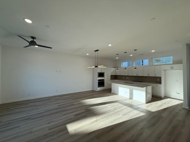 interior space featuring sink, ceiling fan, and light hardwood / wood-style flooring