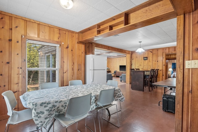 dining space featuring wooden walls