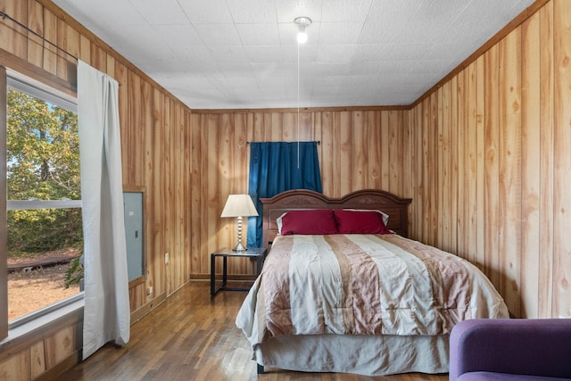 bedroom with wooden walls and wood finished floors