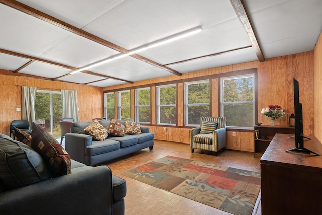 living area featuring wood walls, coffered ceiling, beam ceiling, and wood finished floors