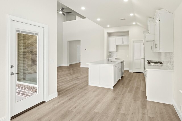 kitchen with appliances with stainless steel finishes, sink, a center island with sink, and white cabinets