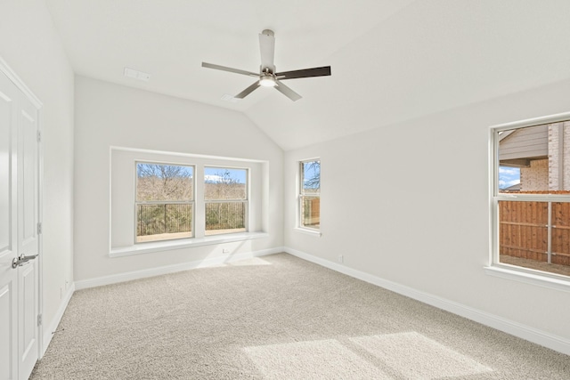 empty room featuring vaulted ceiling, carpet, and ceiling fan