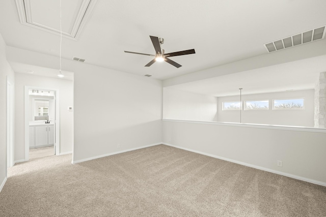 carpeted empty room featuring vaulted ceiling