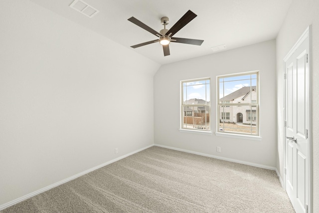 interior space featuring ceiling fan, lofted ceiling, and carpet