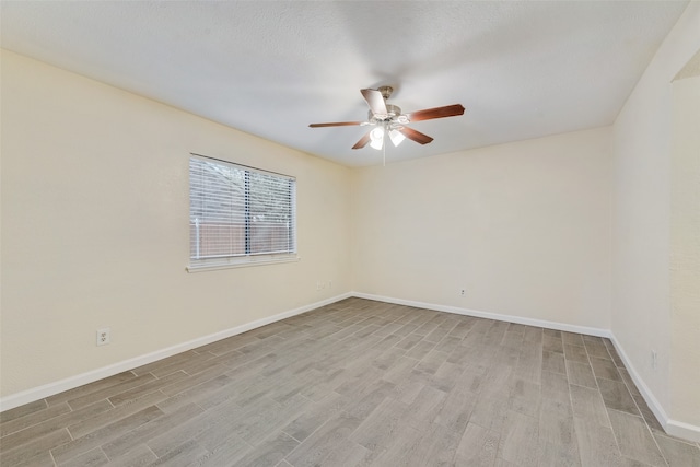 spare room with ceiling fan and light hardwood / wood-style flooring