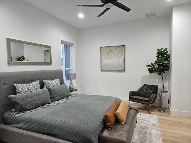 bedroom with ceiling fan and light wood-type flooring