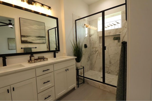 bathroom with ceiling fan, vanity, tile patterned flooring, and a shower with shower door