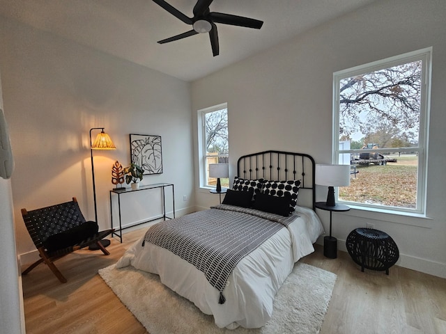 bedroom with ceiling fan and light wood-type flooring