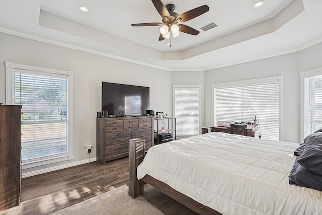 bedroom featuring dark hardwood / wood-style flooring, multiple windows, and ceiling fan