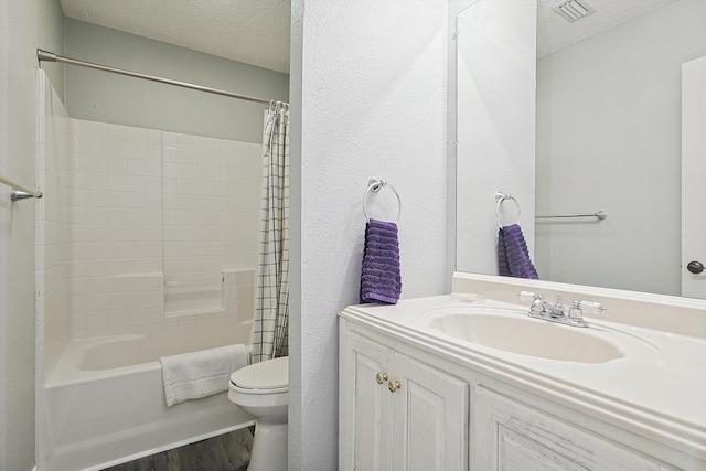 full bathroom with toilet, a textured ceiling, shower / bath combination with curtain, and vanity