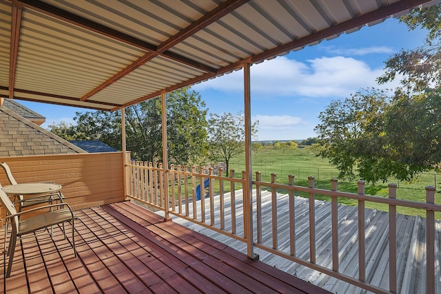 wooden deck featuring a lawn