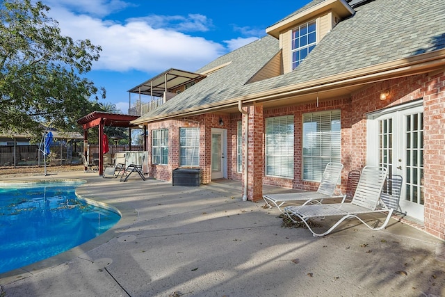 view of swimming pool featuring french doors and a patio area