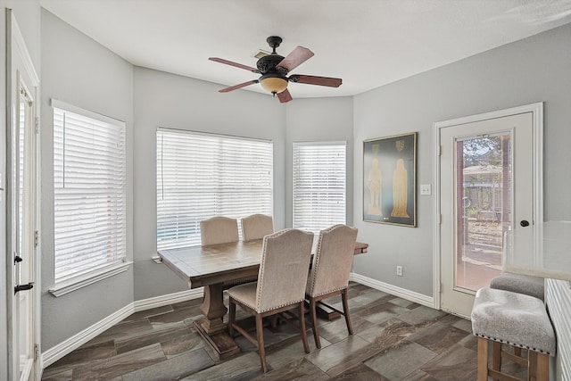 dining space with dark hardwood / wood-style floors and ceiling fan