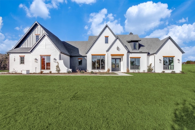 modern farmhouse style home featuring a front lawn