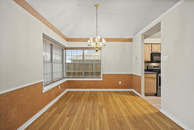 unfurnished dining area with a textured ceiling, lofted ceiling, light hardwood / wood-style flooring, and an inviting chandelier