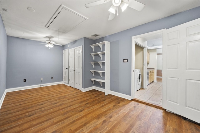 interior space with ceiling fan, light hardwood / wood-style floors, washer / clothes dryer, and connected bathroom