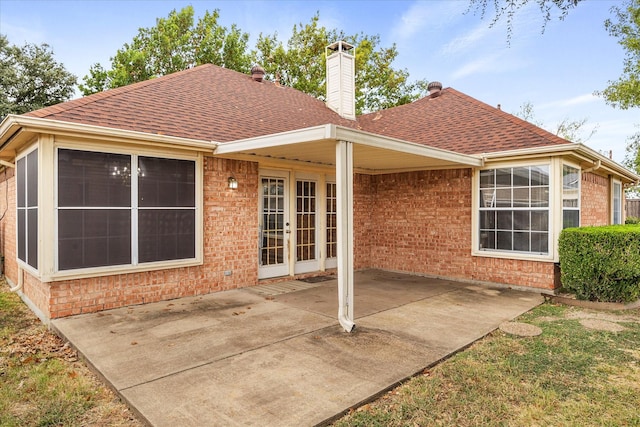 rear view of property featuring french doors and a patio