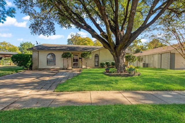 single story home with a front yard and central AC