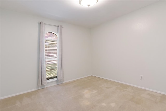 unfurnished room with light colored carpet