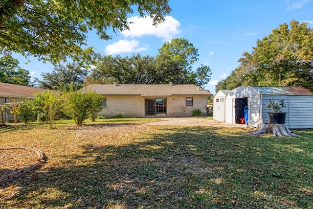 back of property with a shed and a lawn