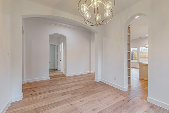 unfurnished dining area with light hardwood / wood-style flooring and a notable chandelier