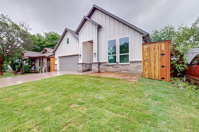 modern farmhouse style home with a front yard and a garage