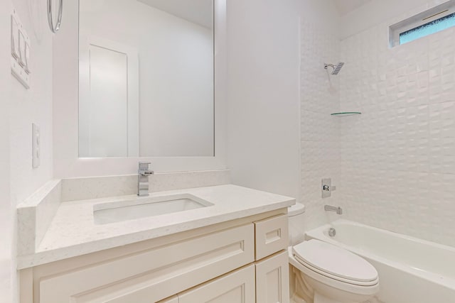 full bathroom with tiled shower / bath, vanity, and toilet