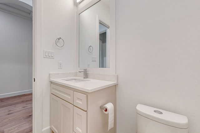 bathroom with vanity, hardwood / wood-style floors, and toilet