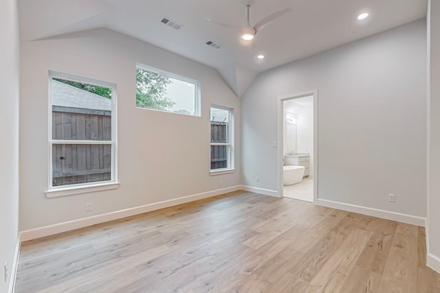 empty room featuring ceiling fan, lofted ceiling, and light wood-type flooring