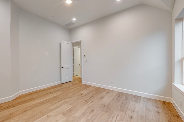 unfurnished room with lofted ceiling and light hardwood / wood-style floors