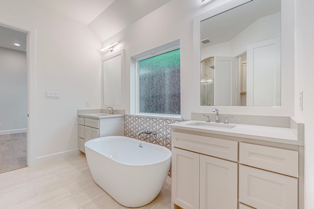 bathroom with vanity and independent shower and bath