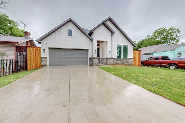 modern farmhouse with a front yard and a garage