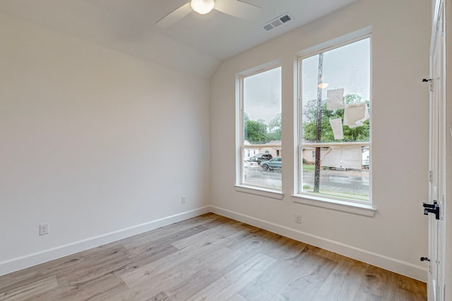 empty room with light hardwood / wood-style flooring, vaulted ceiling, and ceiling fan