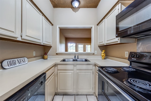 kitchen with white cabinets, light tile patterned floors, a textured ceiling, black appliances, and sink