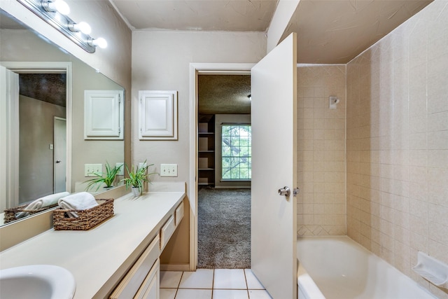 bathroom with tiled shower / bath combo, vanity, tile patterned floors, and a textured ceiling