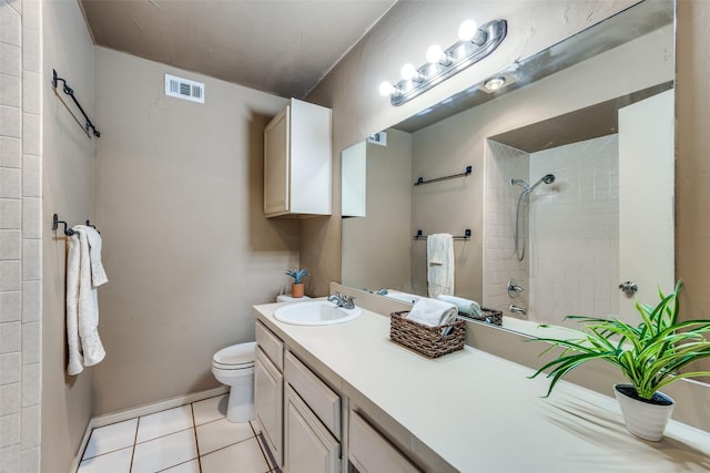 full bathroom with vanity, tiled shower / bath, tile patterned floors, and toilet